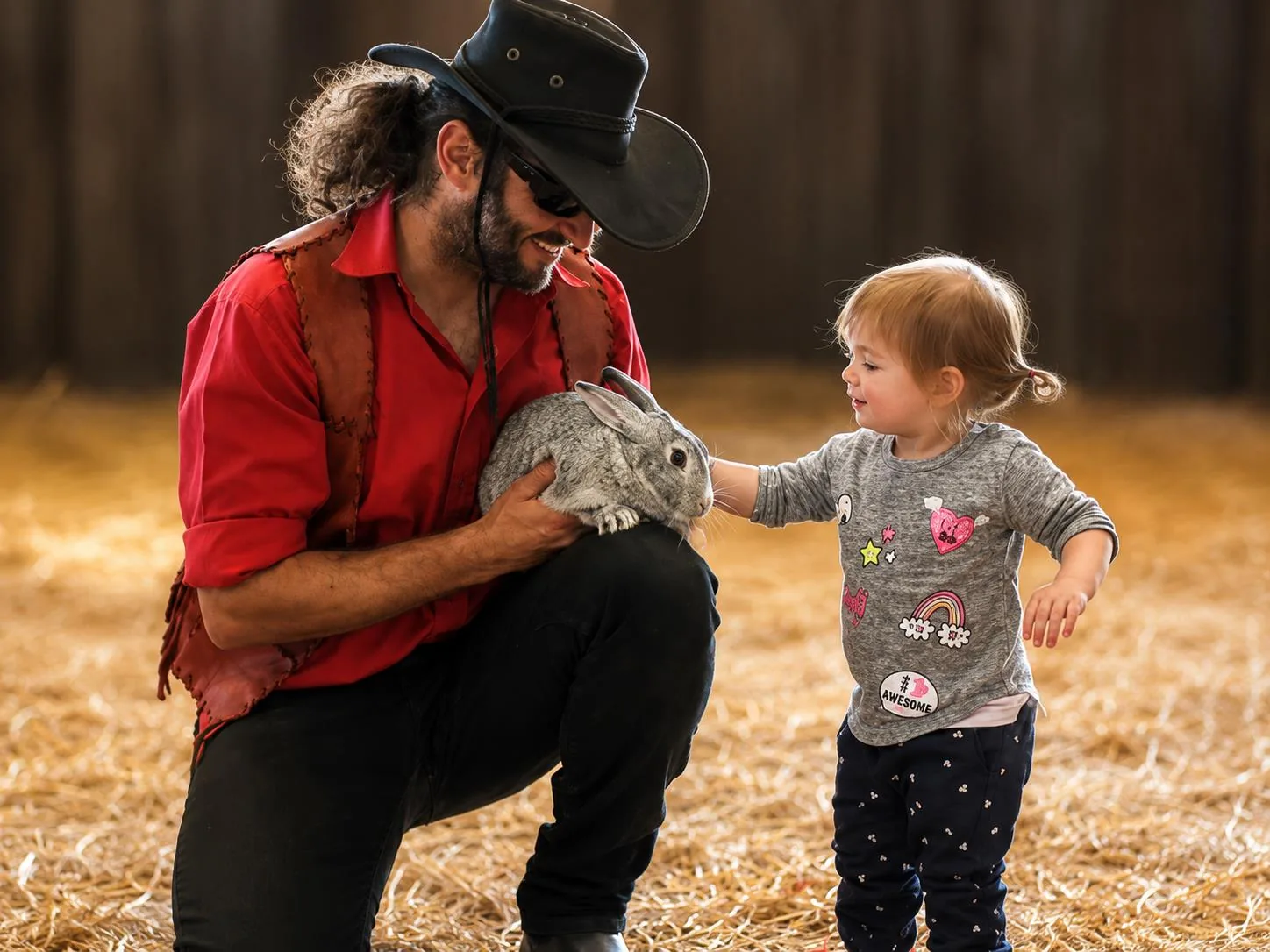 Cowboy and toddler with rabbit at Lat Wai